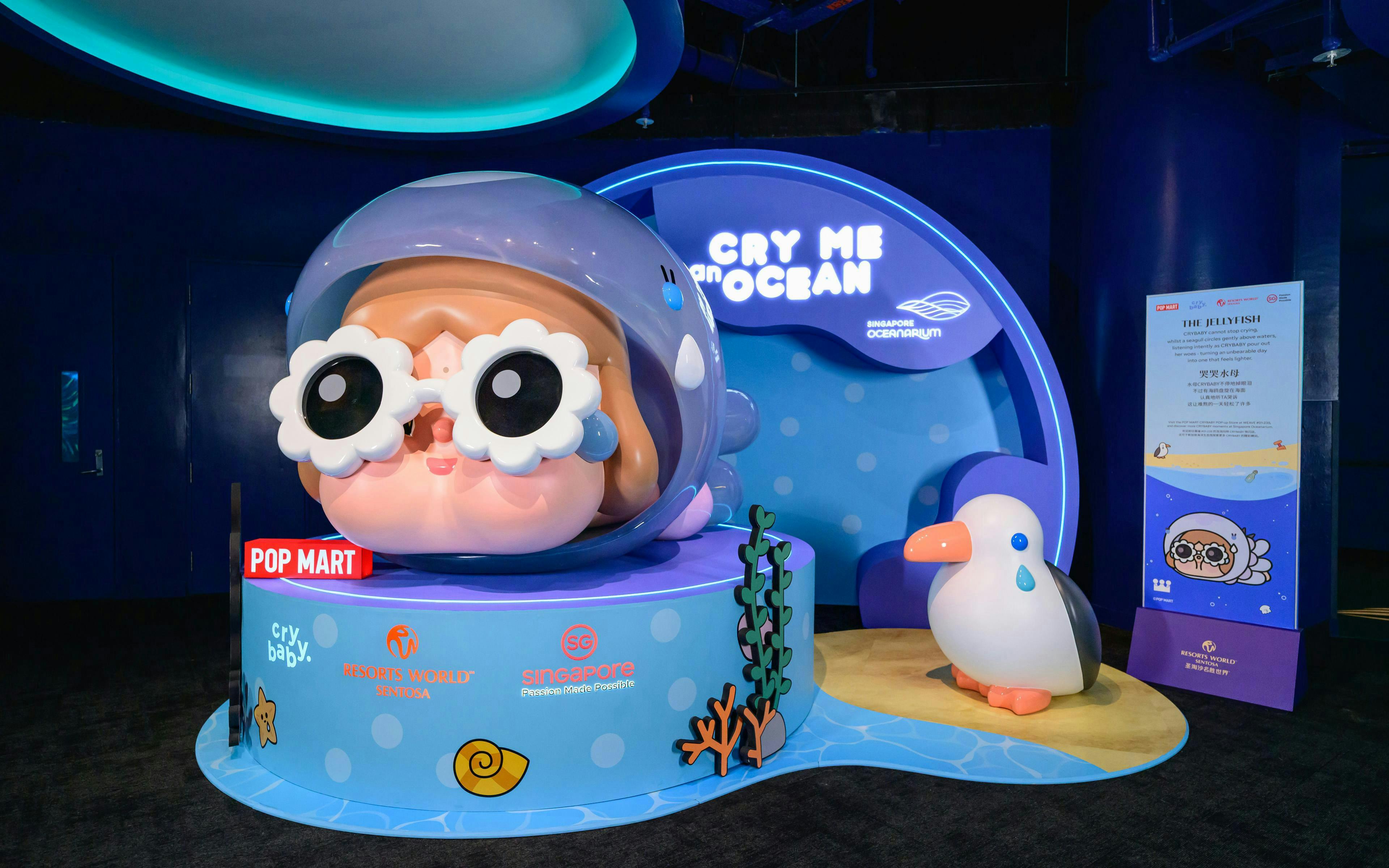 Singapore Oceanarium Pop Mart display featuring a large cartoon character with goggles and a penguin figure.
