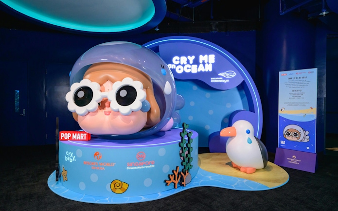 Singapore Oceanarium Pop Mart display featuring a large cartoon character with goggles and a penguin figure.