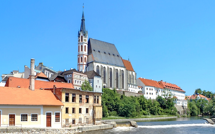St. Vitus Cathedral in Cesky Krumlov with Gothic architecture and historic buildings along the river.
