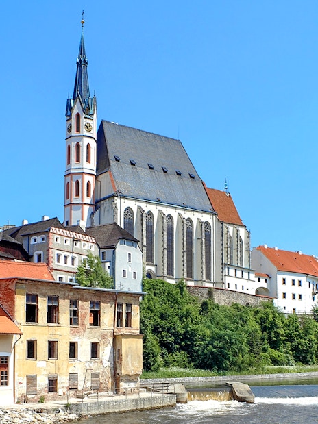 St. Vitus Cathedral in Cesky Krumlov with Gothic architecture and historic buildings along the river.