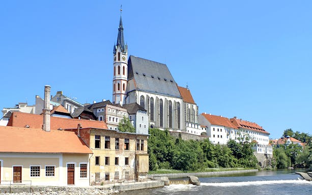 St. Vitus Cathedral in Cesky Krumlov with Gothic architecture and historic buildings along the river.