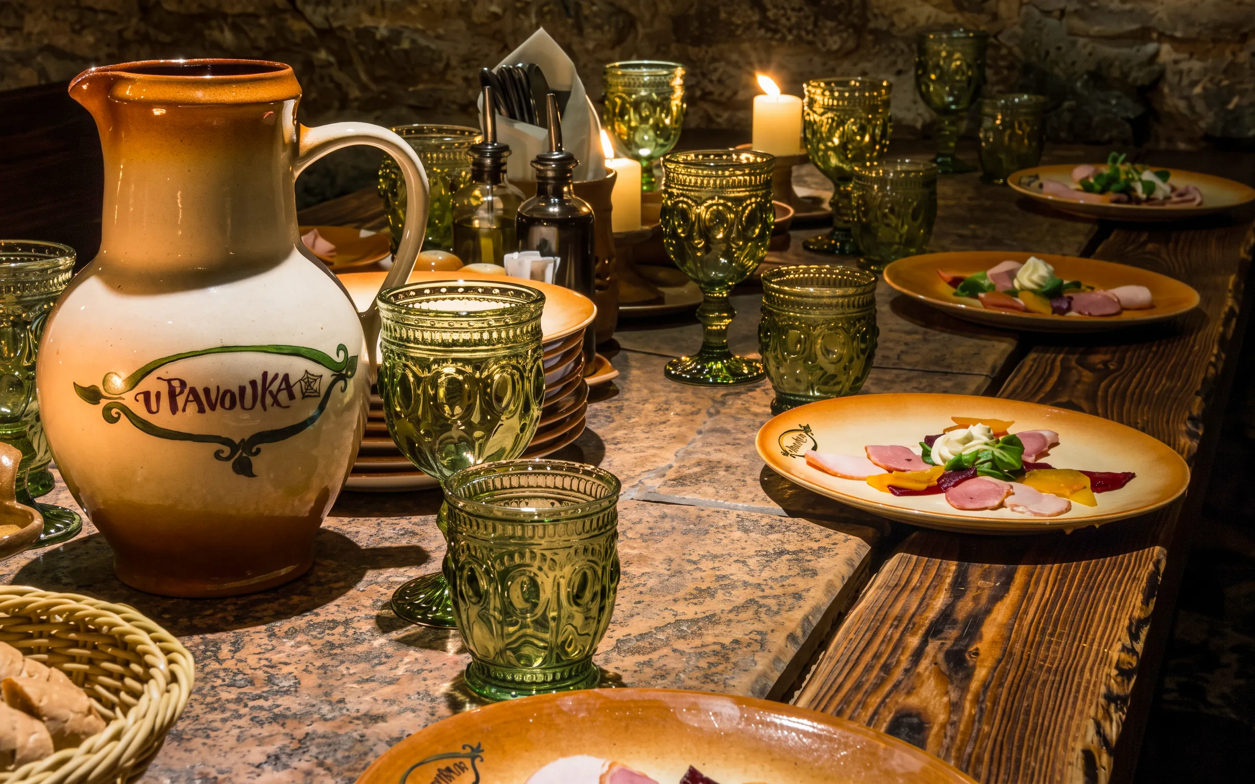 Medieval dinner table setting with ceramic jug and plates in Prague.