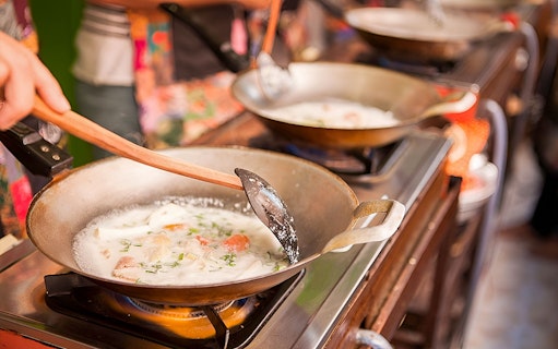 Cooking Thai dish at Silom Thai Cooking School in Bangkok.