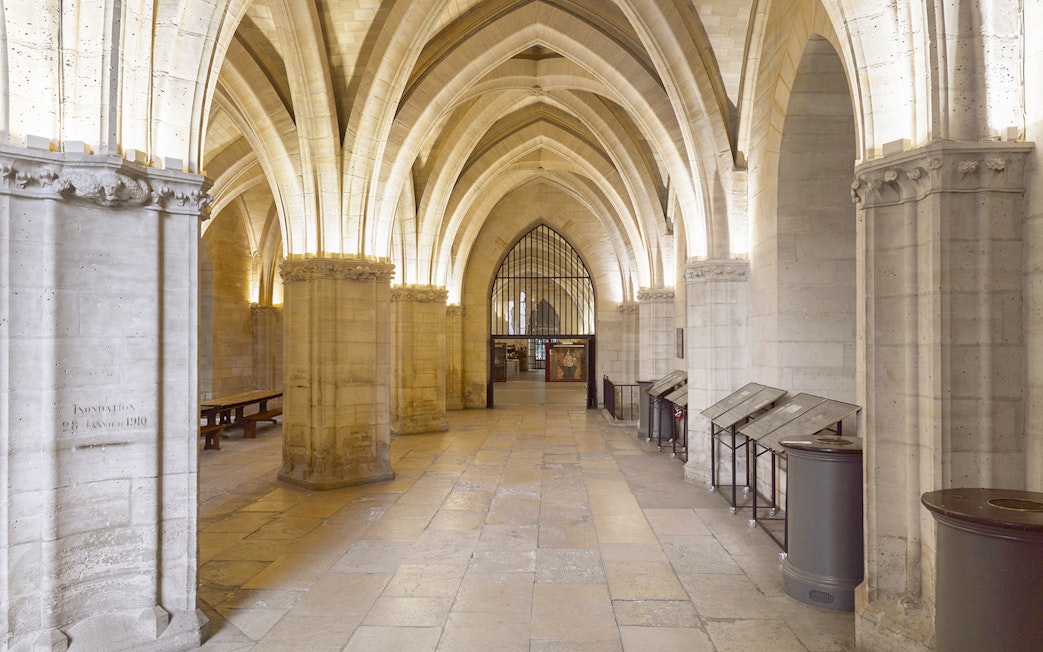 Sainte Chapelle interior with vaulted ceilings and historical displays, Paris.