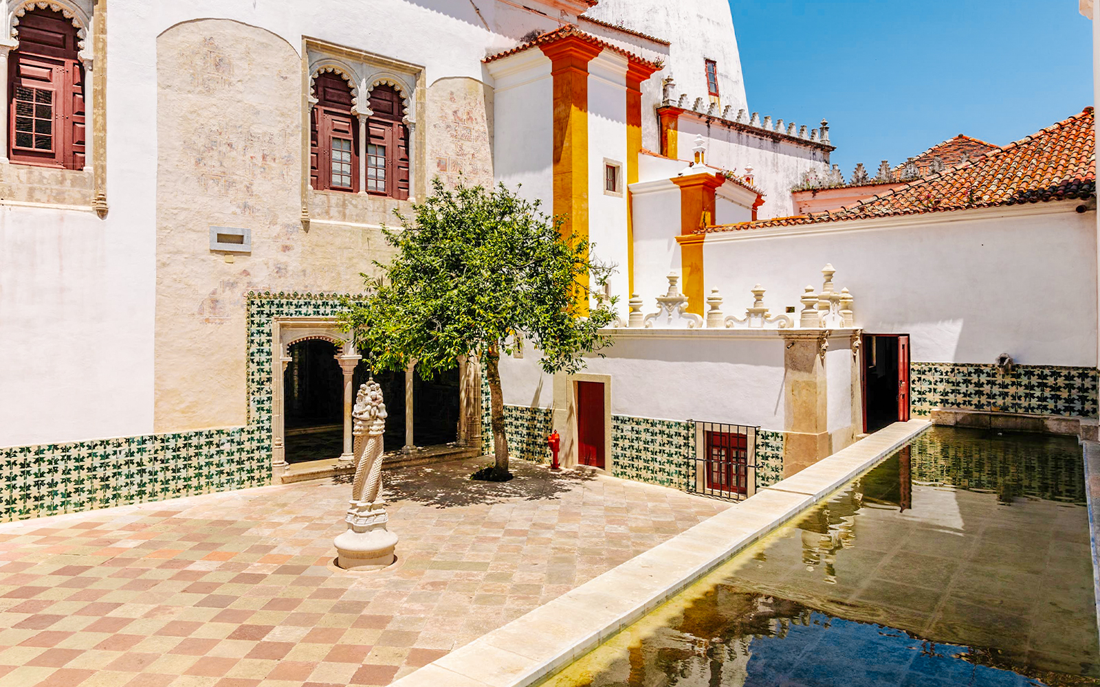 Sintra National Palace central courtyard with tree and bathing cave.