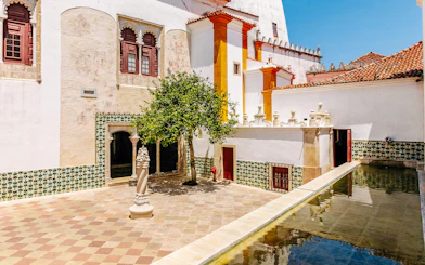 Sintra National Palace central courtyard with tree and bathing cave.