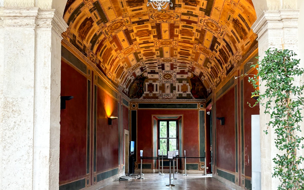 Frescoed room interior at Villa d'Este, Tivoli, Italy, showcasing intricate ceiling designs.