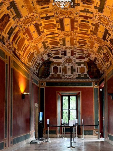 Frescoed room interior at Villa d'Este, Tivoli, Italy, showcasing intricate ceiling designs.
