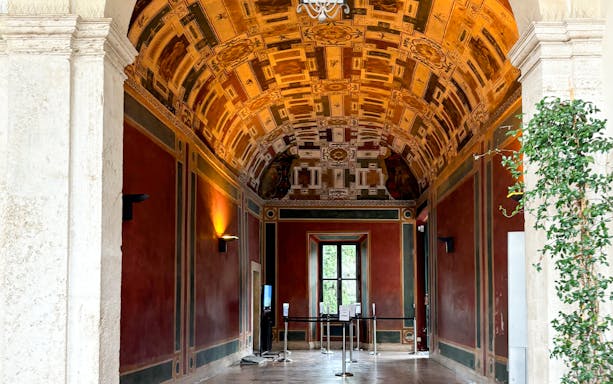 Frescoed room interior at Villa d'Este, Tivoli, Italy, showcasing intricate ceiling designs.