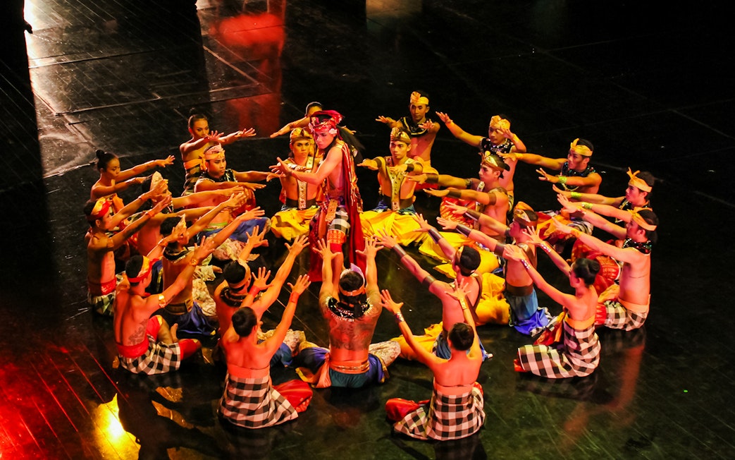 Performers in traditional attire at the Devdan Show, Bali, showcasing Indonesian dance.
