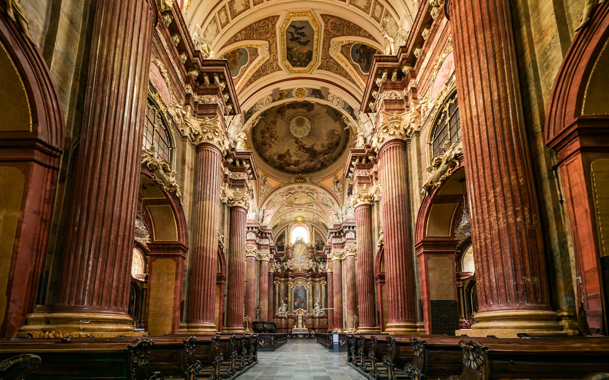 Interior of St Paul's Cathedral with ornate columns and detailed ceiling artwork.