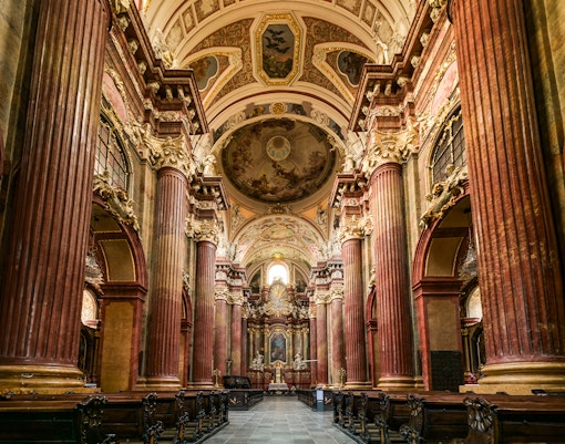 Interior of St Paul's Cathedral with ornate columns and detailed ceiling artwork.