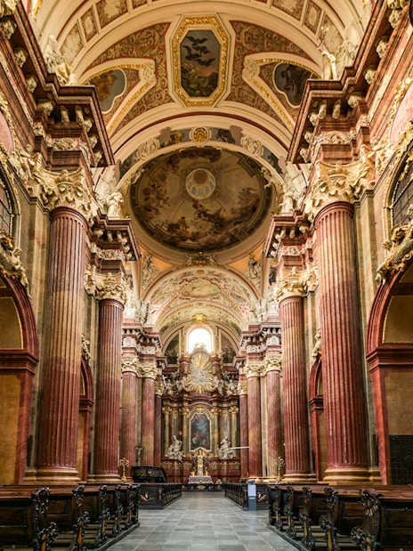 Interior of St Paul's Cathedral with ornate columns and detailed ceiling artwork.