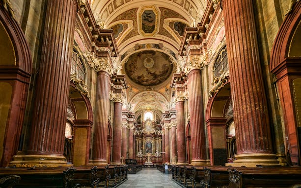 Interior of St Paul's Cathedral with ornate columns and detailed ceiling artwork.