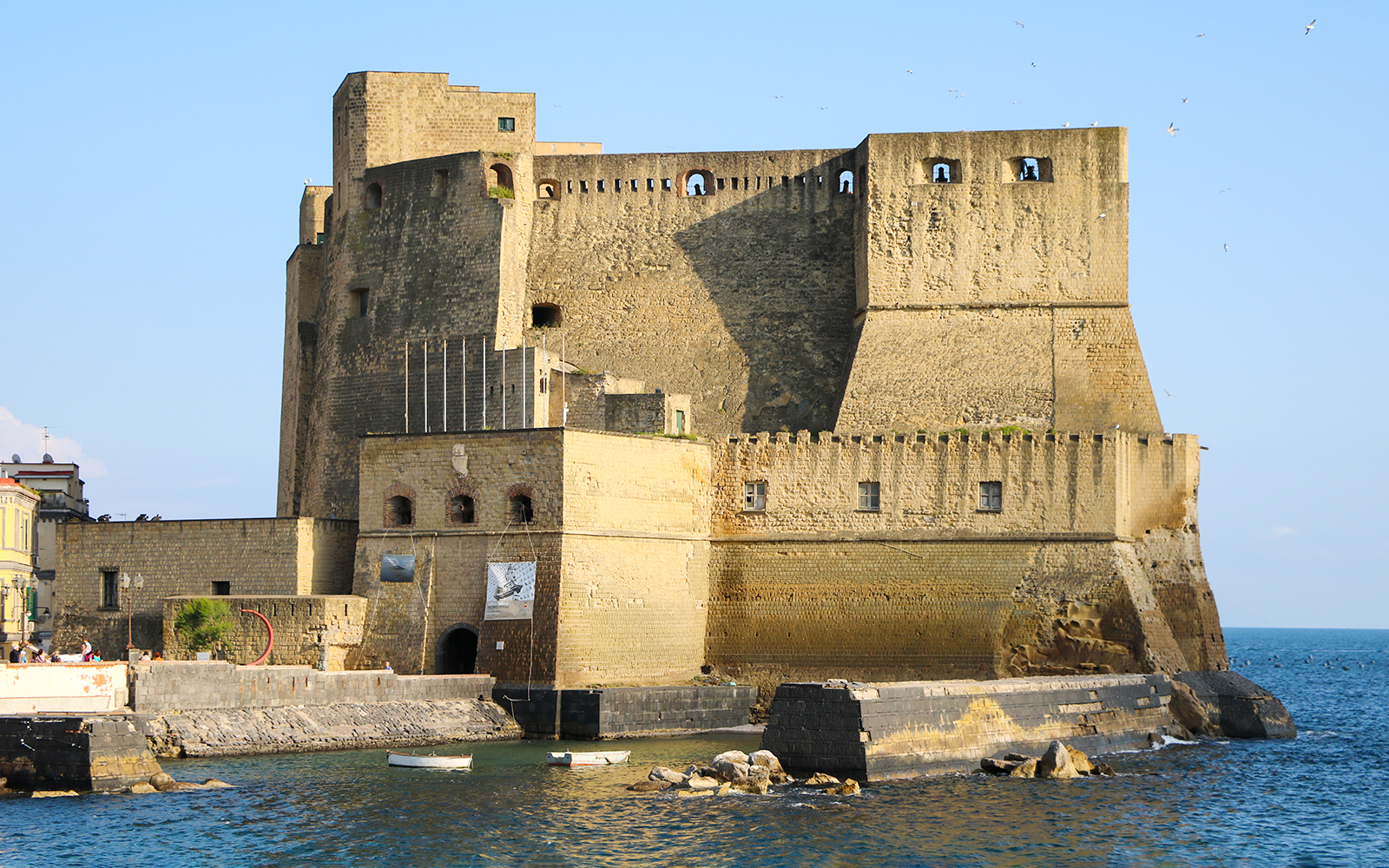 Castel dell'Ovo on the waterfront in Naples, Italy, part of the monumental district tour.