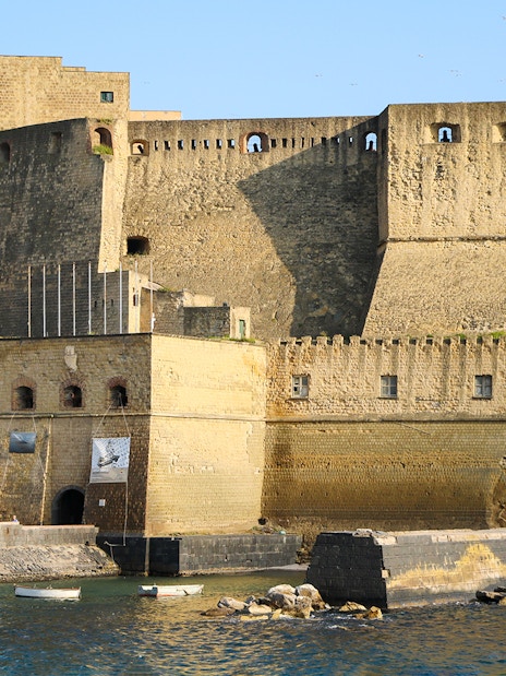 Castel dell'Ovo on the waterfront in Naples, Italy, part of the monumental district tour.