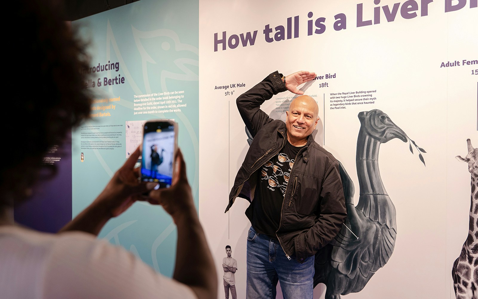 Guest posing with Liver Bird height display inside Royal Liver Building.