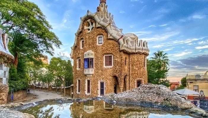 Park Guell's iconic mosaic structures in Barcelona, Spain, with vibrant colors and unique architecture.