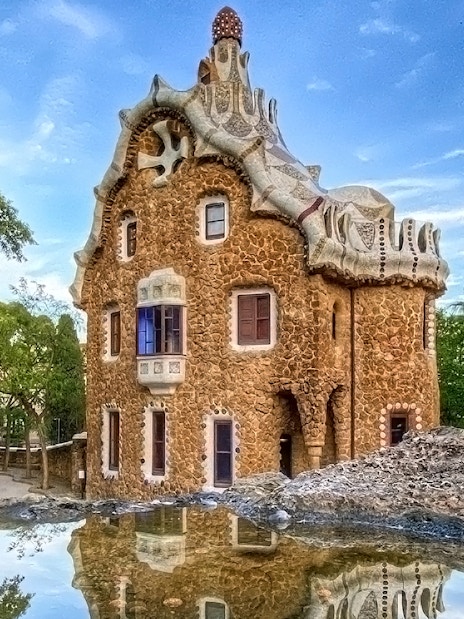 Park Güell's unique stone building with mosaic roof in Barcelona.