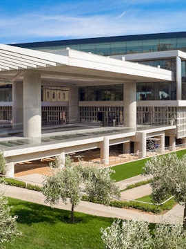 Acropolis Museum exterior with modern architecture and surrounding greenery in Athens, Greece.
