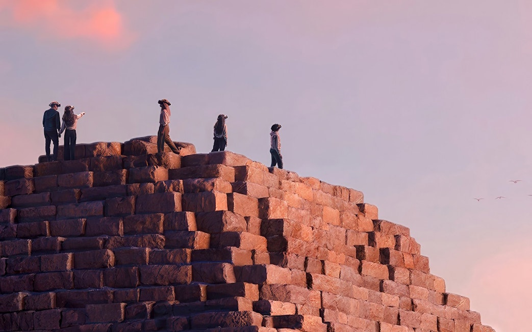 Visitors wearing VR headsets on a pyramid, experiencing Horizon of Khufu virtual reality tour.
