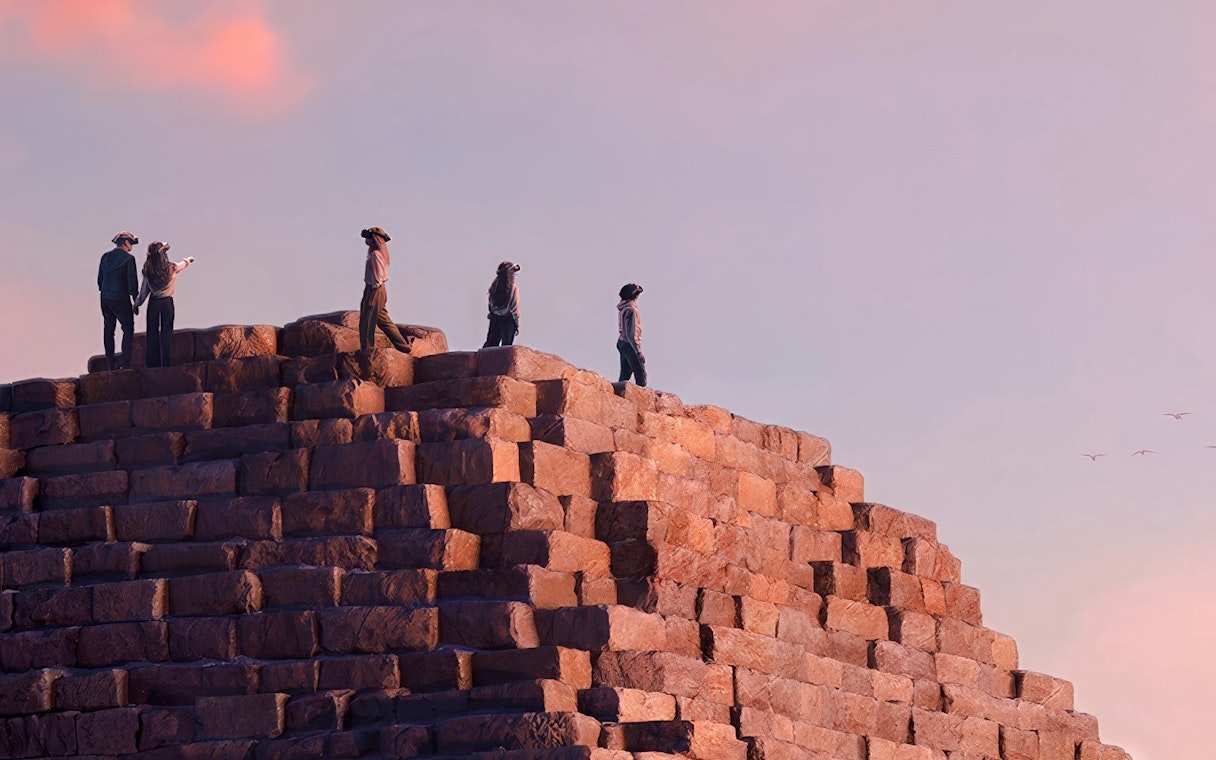 Visitors wearing VR headsets on a pyramid, experiencing Horizon of Khufu virtual reality tour.