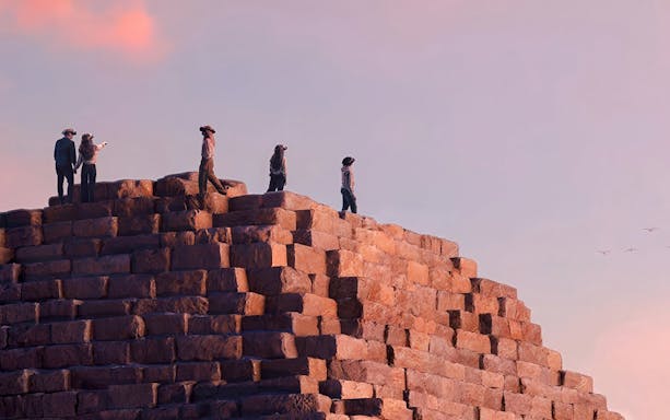 Visitors wearing VR headsets on a pyramid, experiencing Horizon of Khufu virtual reality tour.