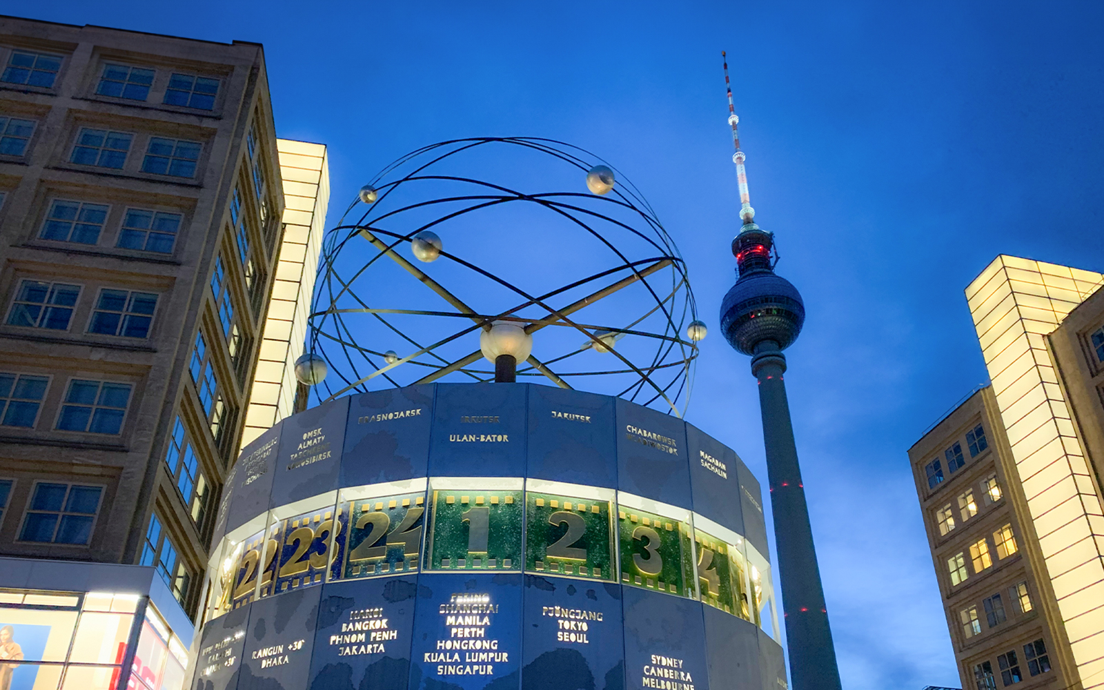 World clock and TV tower in Berlin during panoramic day and evening tour.