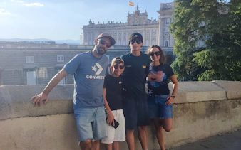 Group posing in front of the Royal Palace during a private tour in Madrid.