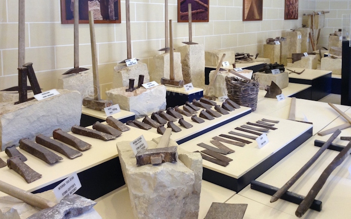 Stone-cutting tools display inside The Limestone Heritage Park & Gardens museum.