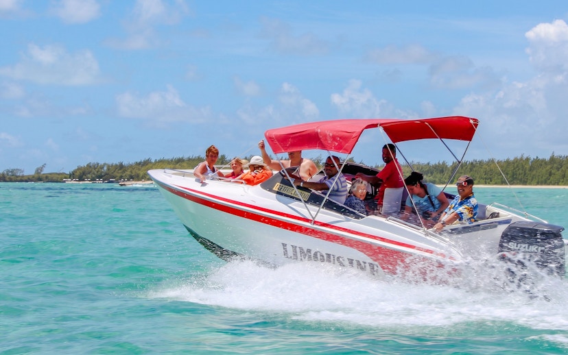 Speedboat with passengers on turquoise waters near Ile Aux Cerf, Mauritius.