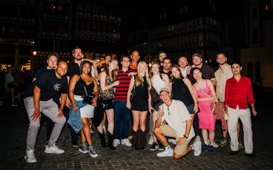 Group enjoying Cologne nightlife tour with club entry and shots.