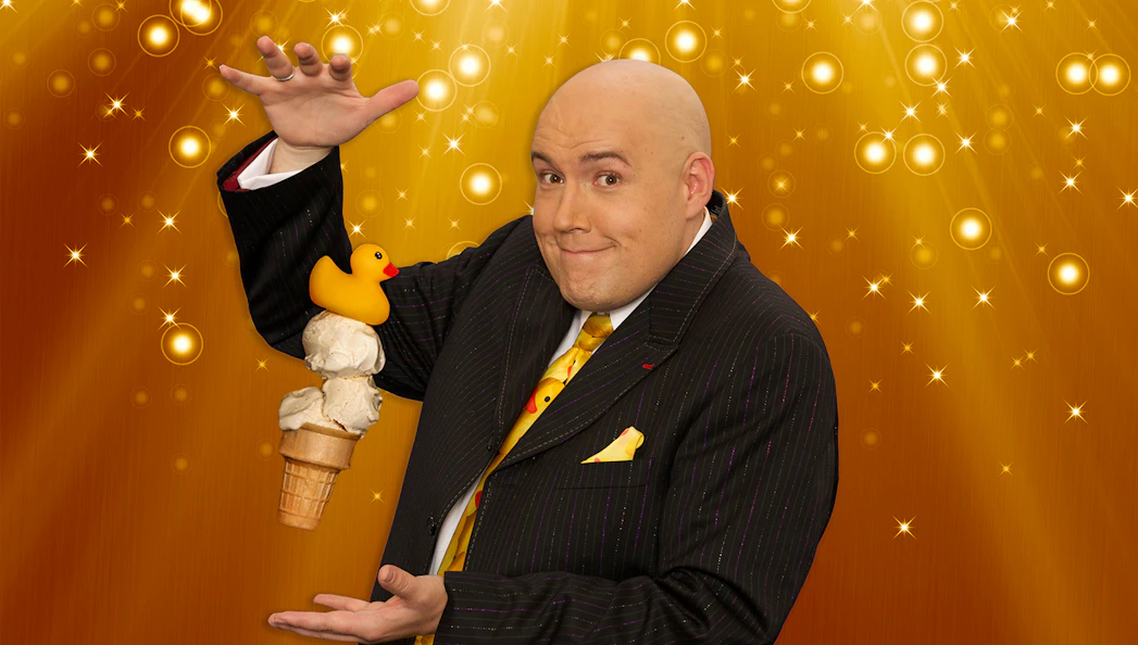 Magician performing with ice cream cone and rubber duck at Adam London Laughternoon.