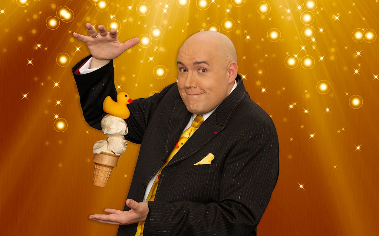 Magician performing with ice cream cone and rubber duck at Adam London Laughternoon.
