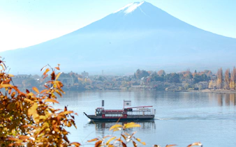 Cruise boat on Lake Kawaguchi with Mount Fuji in the background.
