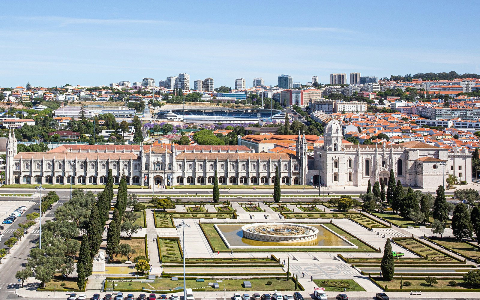 Jerónimos Monastery exterior with tourists on a guided tour in Lisbon, Portugal.