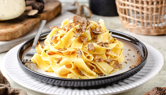 Truffle pasta dish at Delphi Restaurant with shaved truffles on a plate.