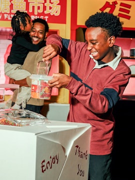 Guests filling candy containers at i Candy NYC experience.