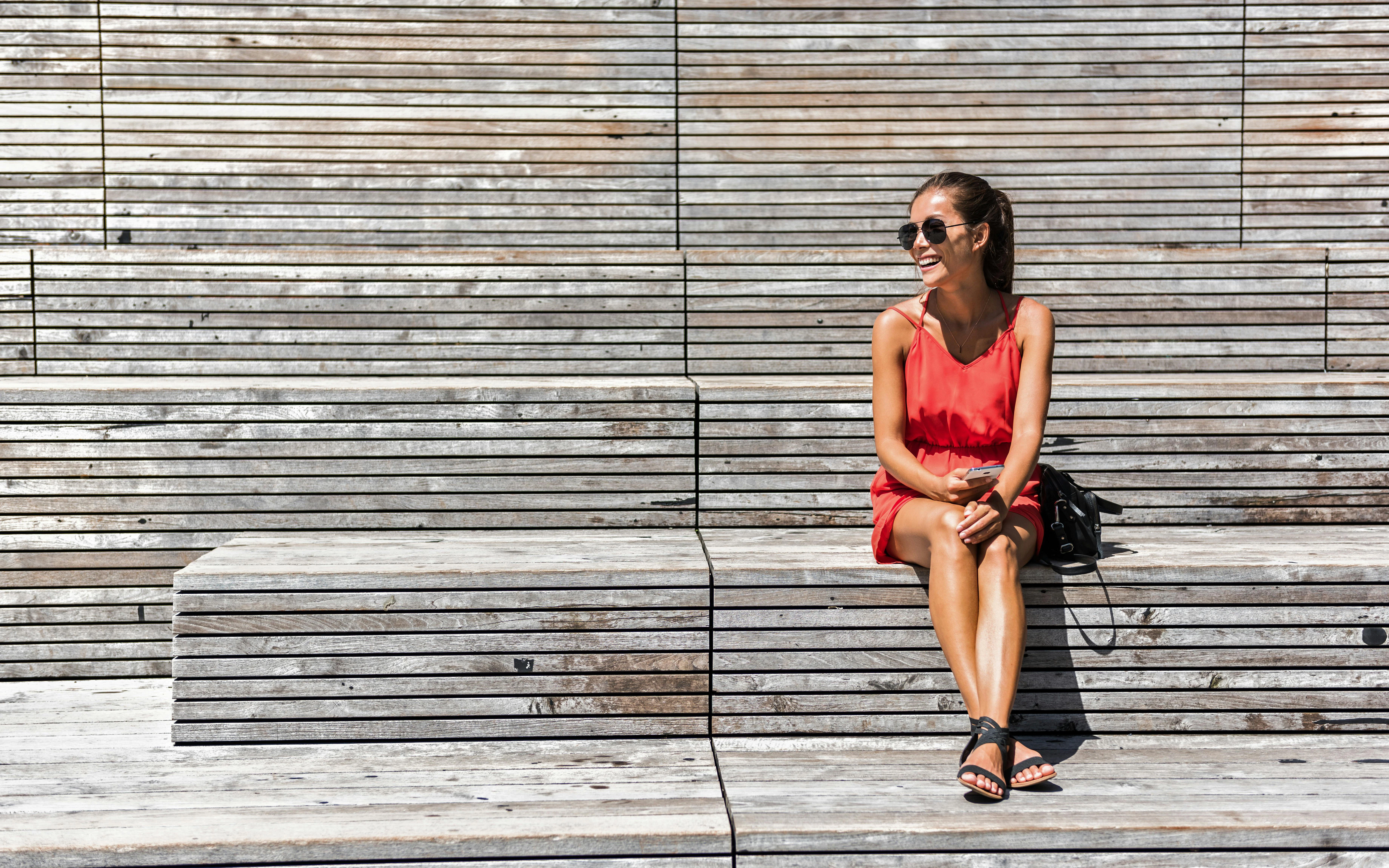 Woman relaxing on a bench on the High Line in Chelsea, New York.