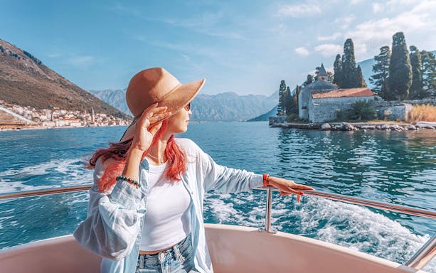 Guests on boat near Our Lady of the Rocks, Montenegro, during private tour.