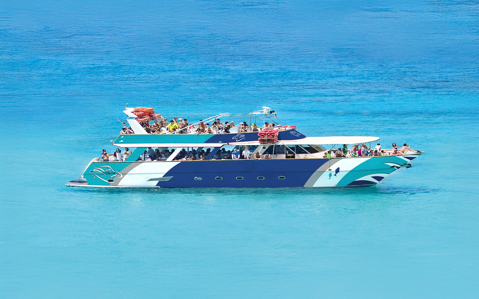 Sea Bird Boat cruising in Blue Lagoon with passengers enjoying the view.