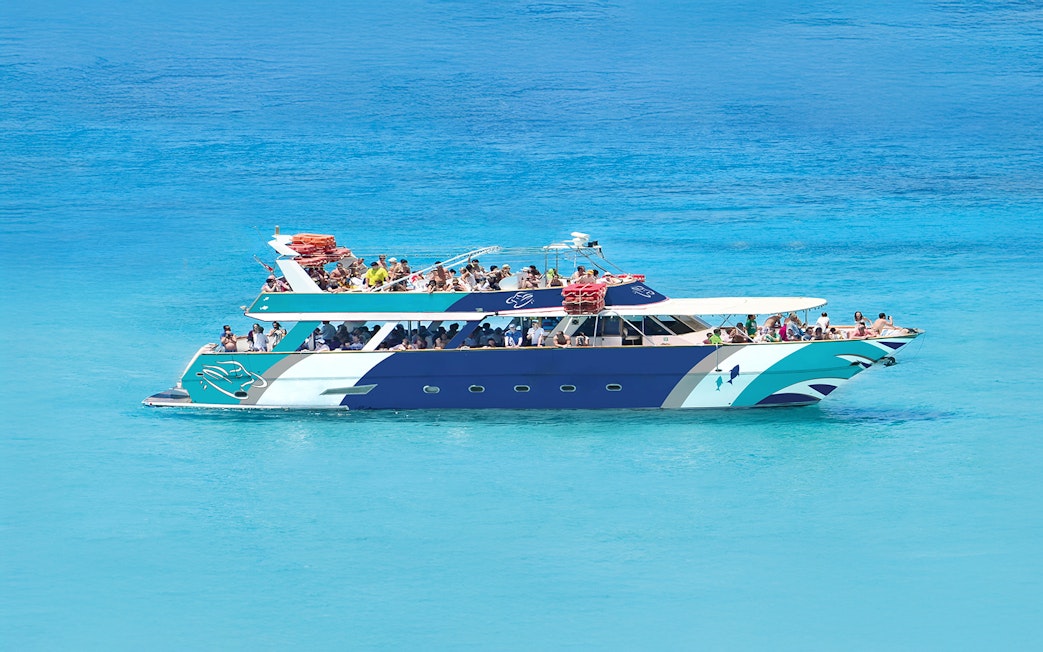 Sea Bird Boat cruising in Blue Lagoon with passengers enjoying the view.