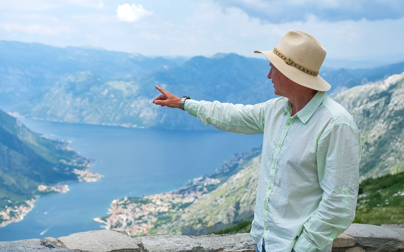 Tour guide pointing at Kotor Bay during Private Montenegro Tour.