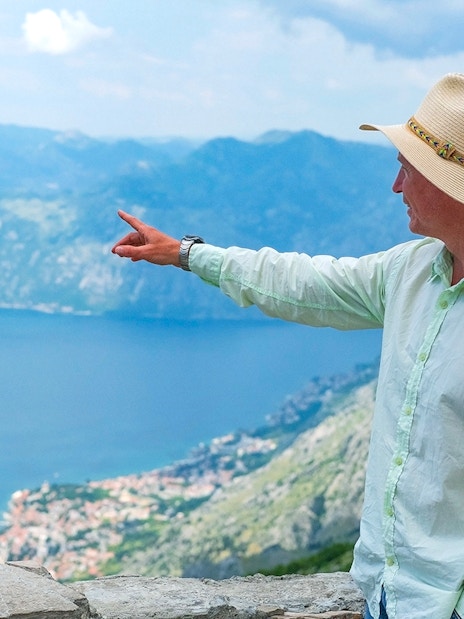 Tour guide pointing at Kotor Bay during Private Montenegro Tour.