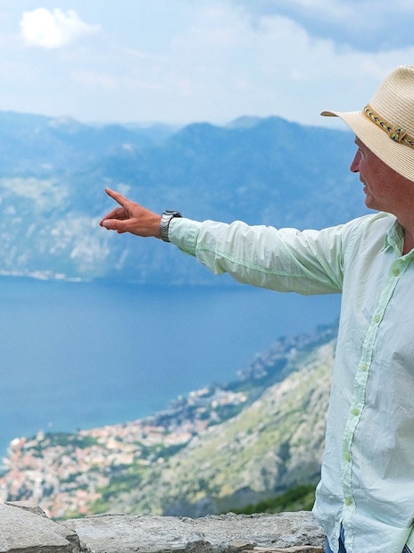 Tour guide pointing at Kotor Bay during Private Montenegro Tour.