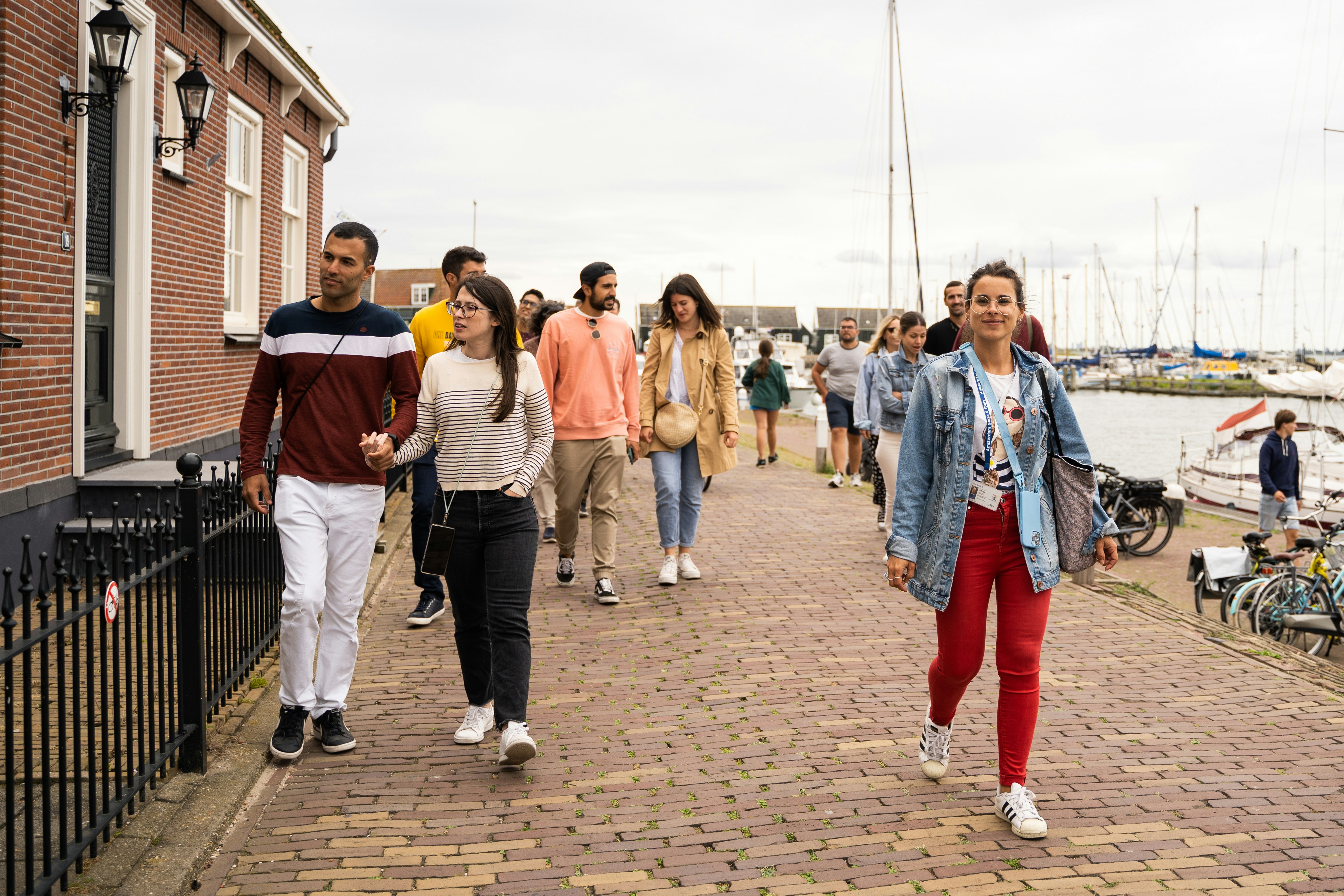 Group walking along a canal in Giethoorn village during a guided tour.