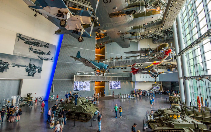 National WWII Museum in New Orleans with vintage aircraft and tanks on display.
