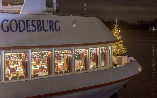 Cruise ship Godesburg decorated with lights and Christmas tree for Advent Afternoon Cruise in Mainz.