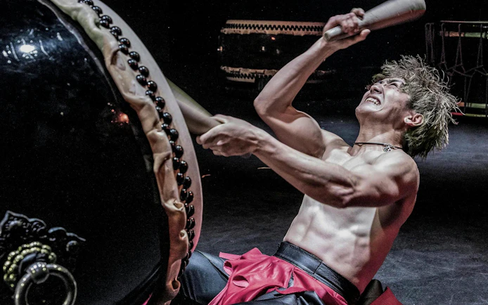 Performer playing taiko drum at DRUM TAO Theater Kyoto.