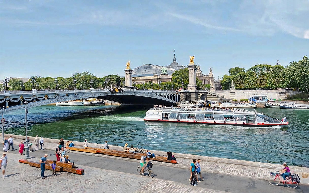 Seine River cruise boat passing under Pont Alexandre III in Paris.